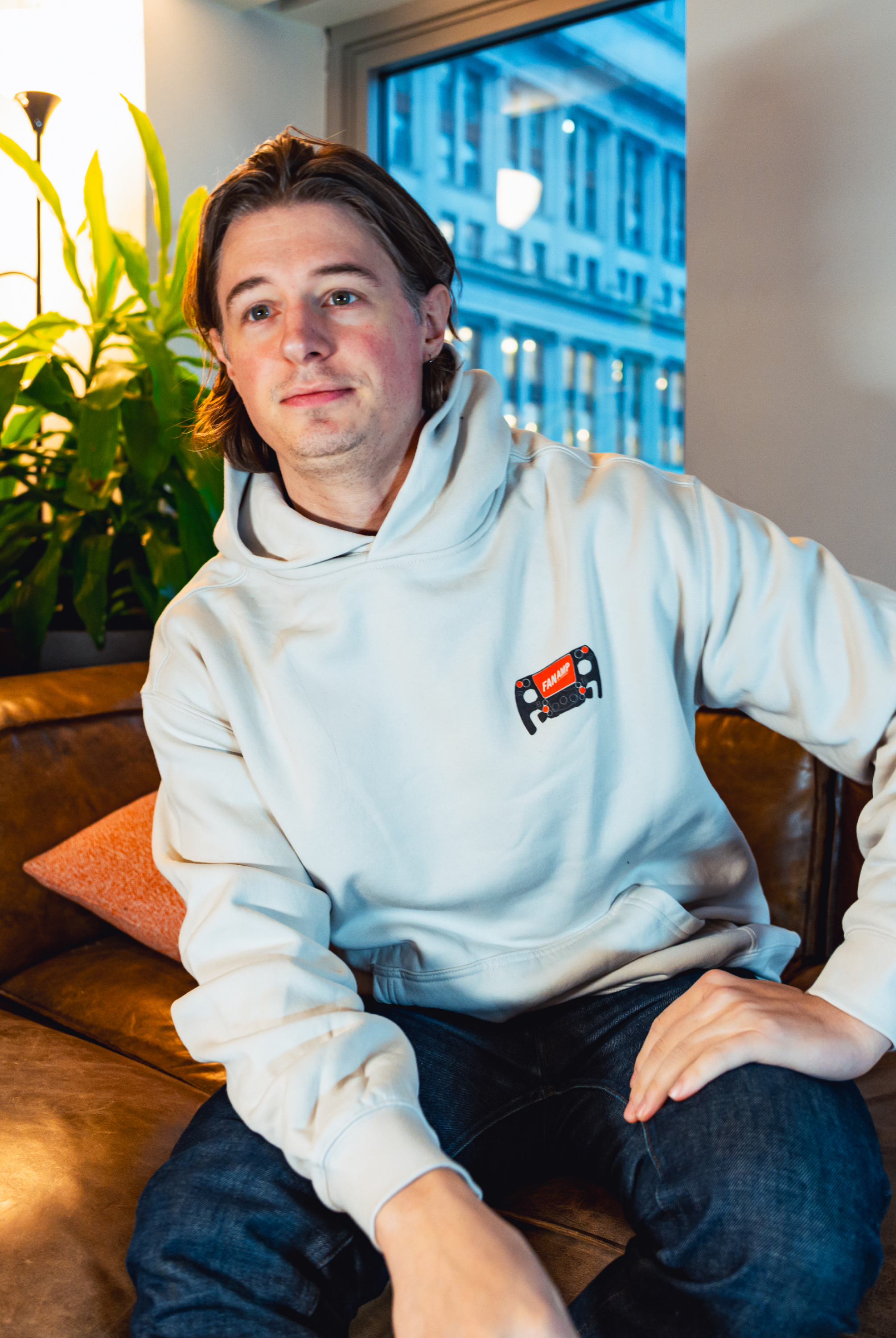 Model in NYC office showing the front of the Bone Make The Pass hoodie