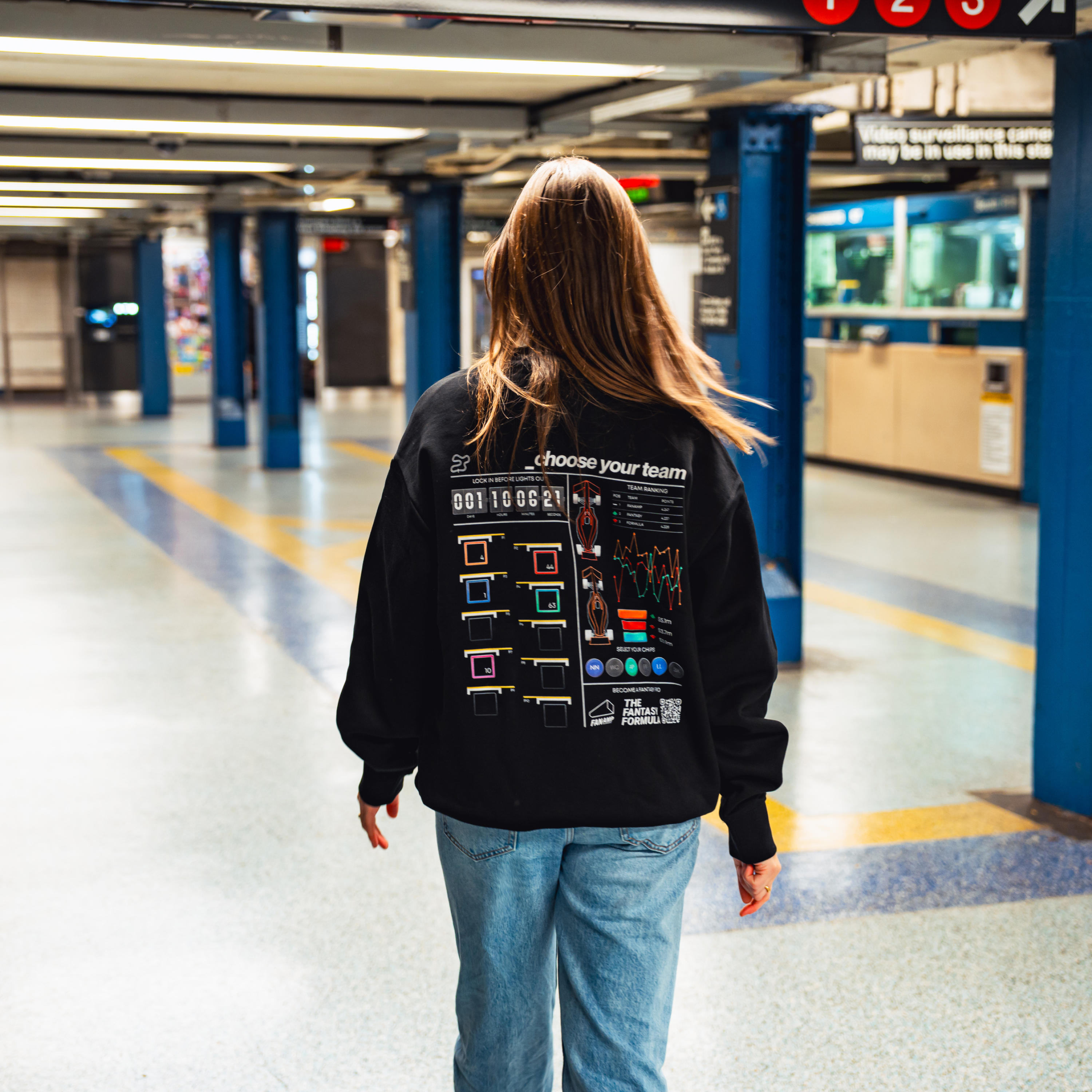 Model in NYC subway showing the back of the Black Fantasy Strategist crewneck