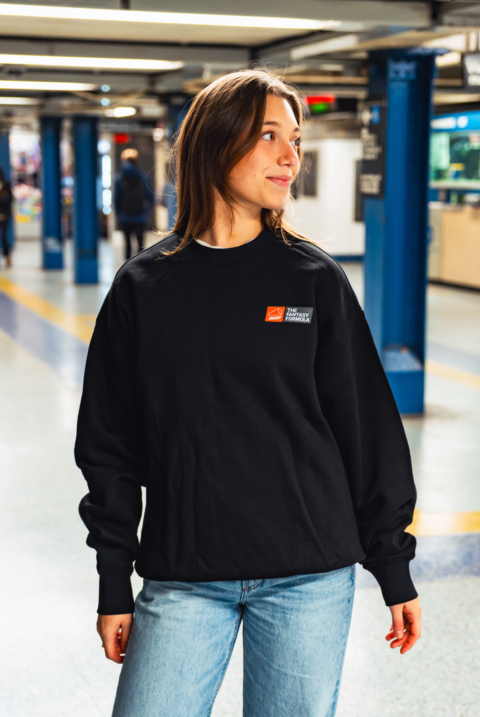 Model in NYC subway showing the front of the Black Fantasy Strategist crewneck