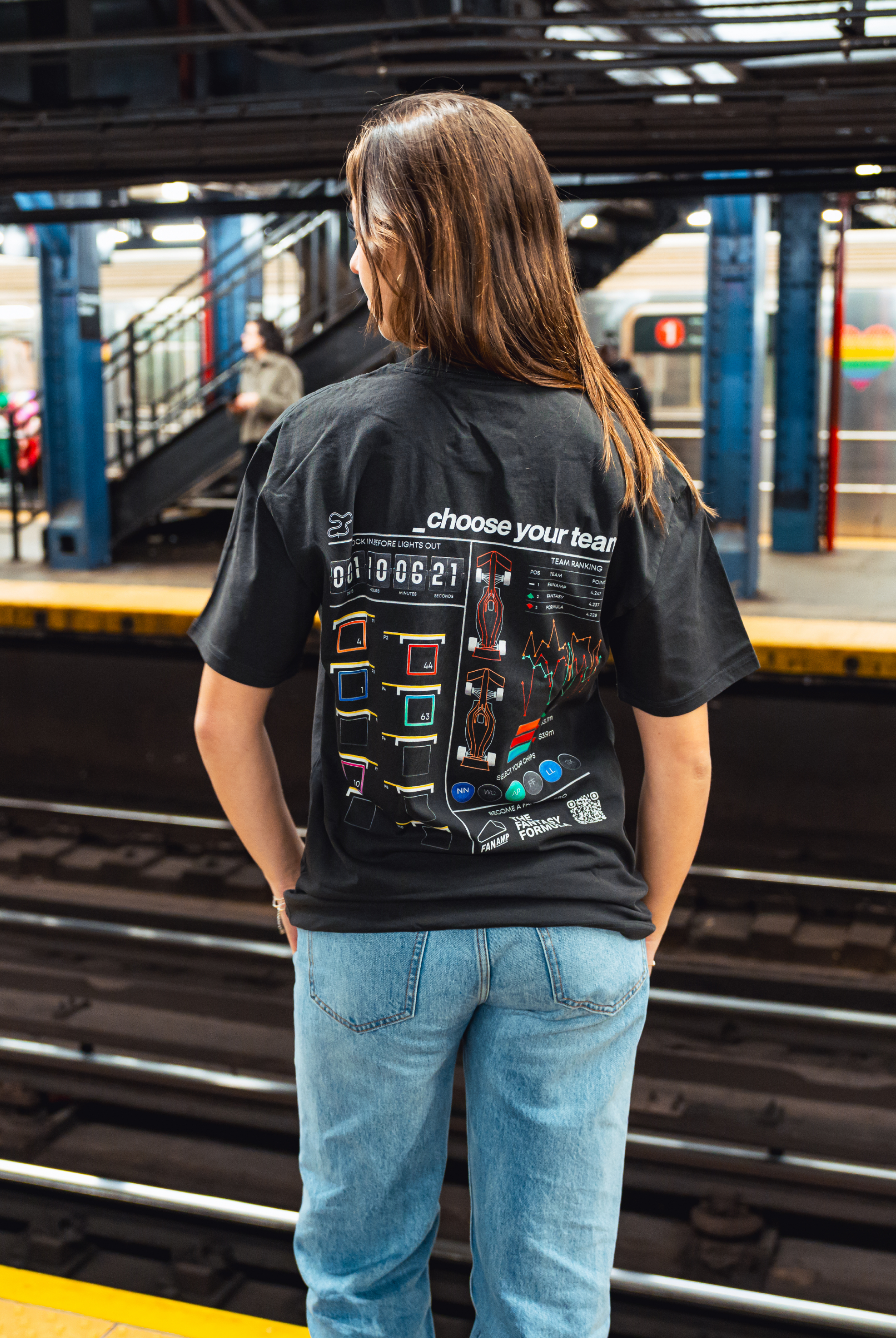 Model in NYC subway showing the back of the Faded Coal Fantasy Strategist t-shirt