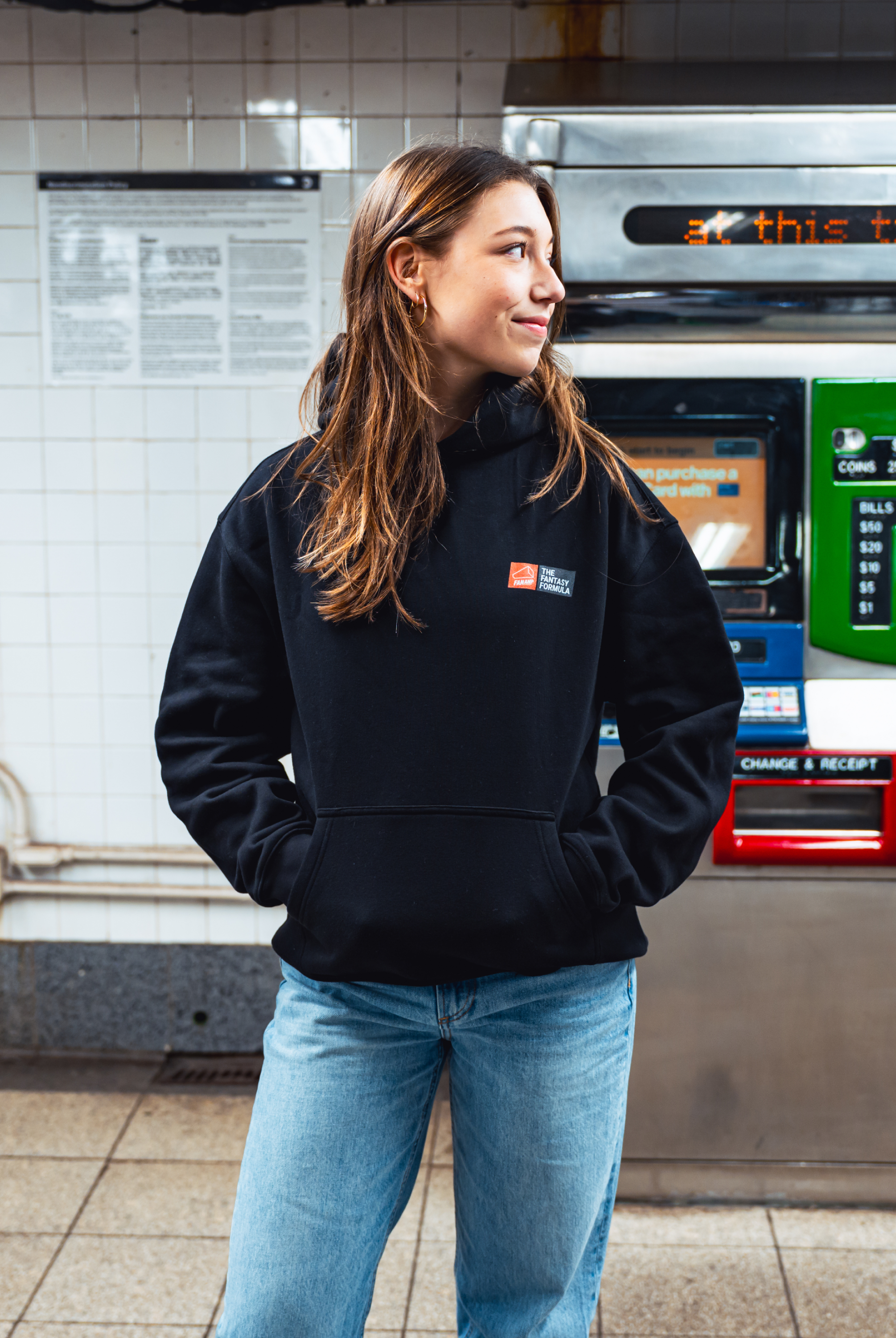 Model in NYC subway showing the front of the Black Fantasy Strategist hoodie
