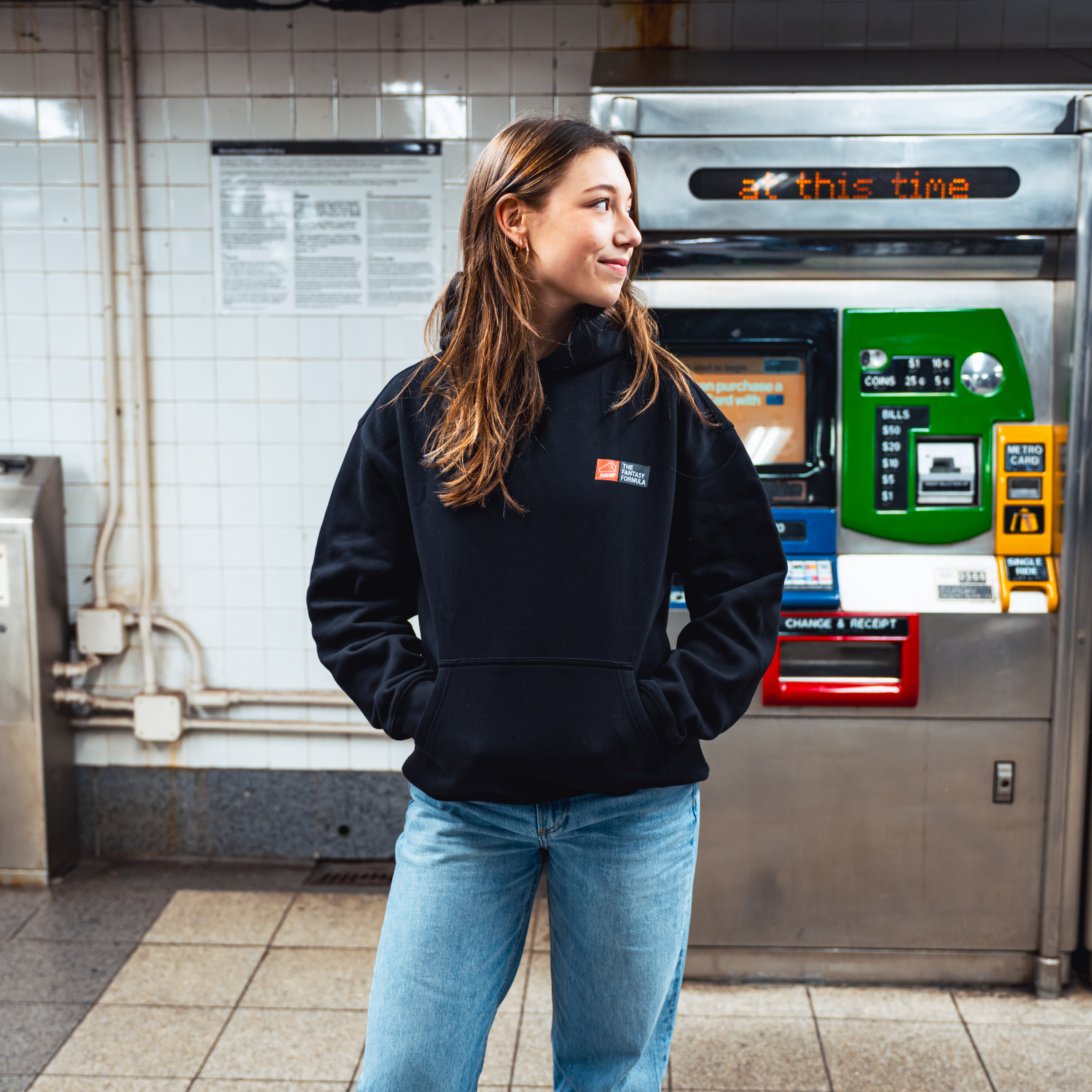 Model in NYC subway showing the front of the Black Fantasy Strategist hoodie