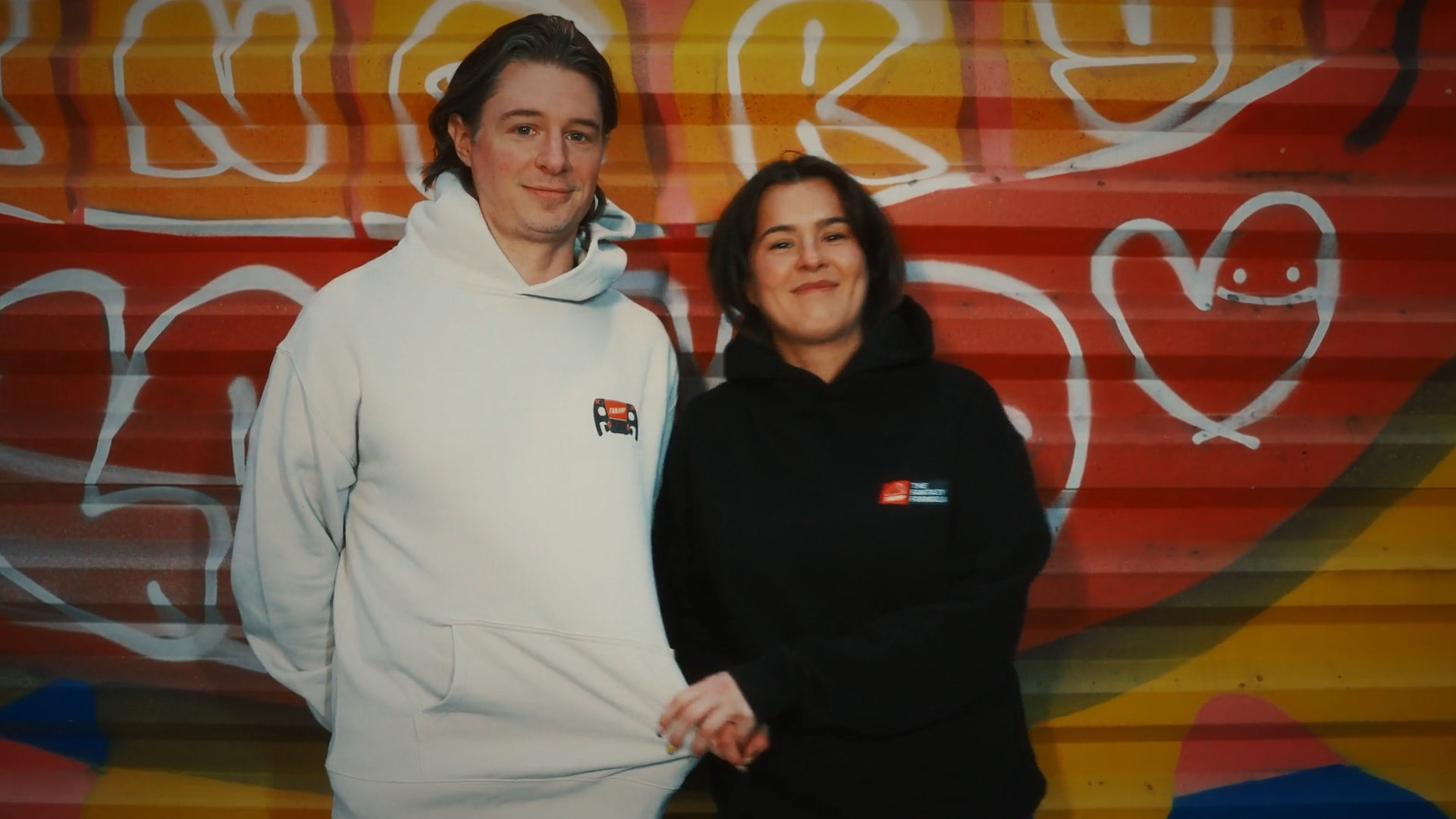 Two models wearing FanAmp hoodies