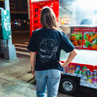 Model in NYC showing the back of the navy Safety First t-shirt