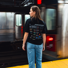 Model in NYC subway showing the back of the Black Fantasy Strategist t-shirt
