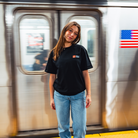 Model in NYC subway showing the front of the Black Fantasy Strategist t-shirt