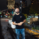 Model in NYC showing the front of the Black Fantasy Strategist t-shirt
