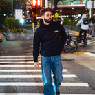 Model in NYC showing the front of the black Fantasy Strategist hoodie